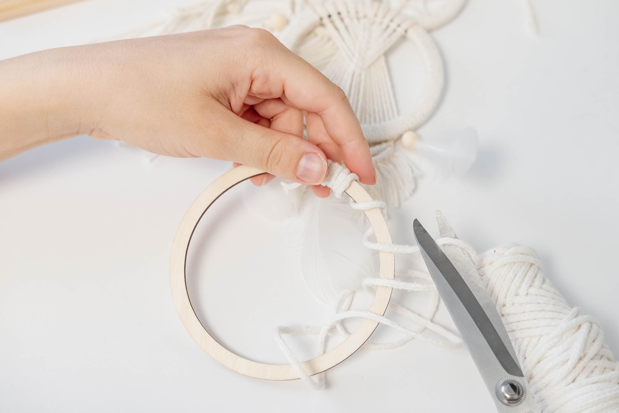 Hand embroiderer at work with hoop and needle
