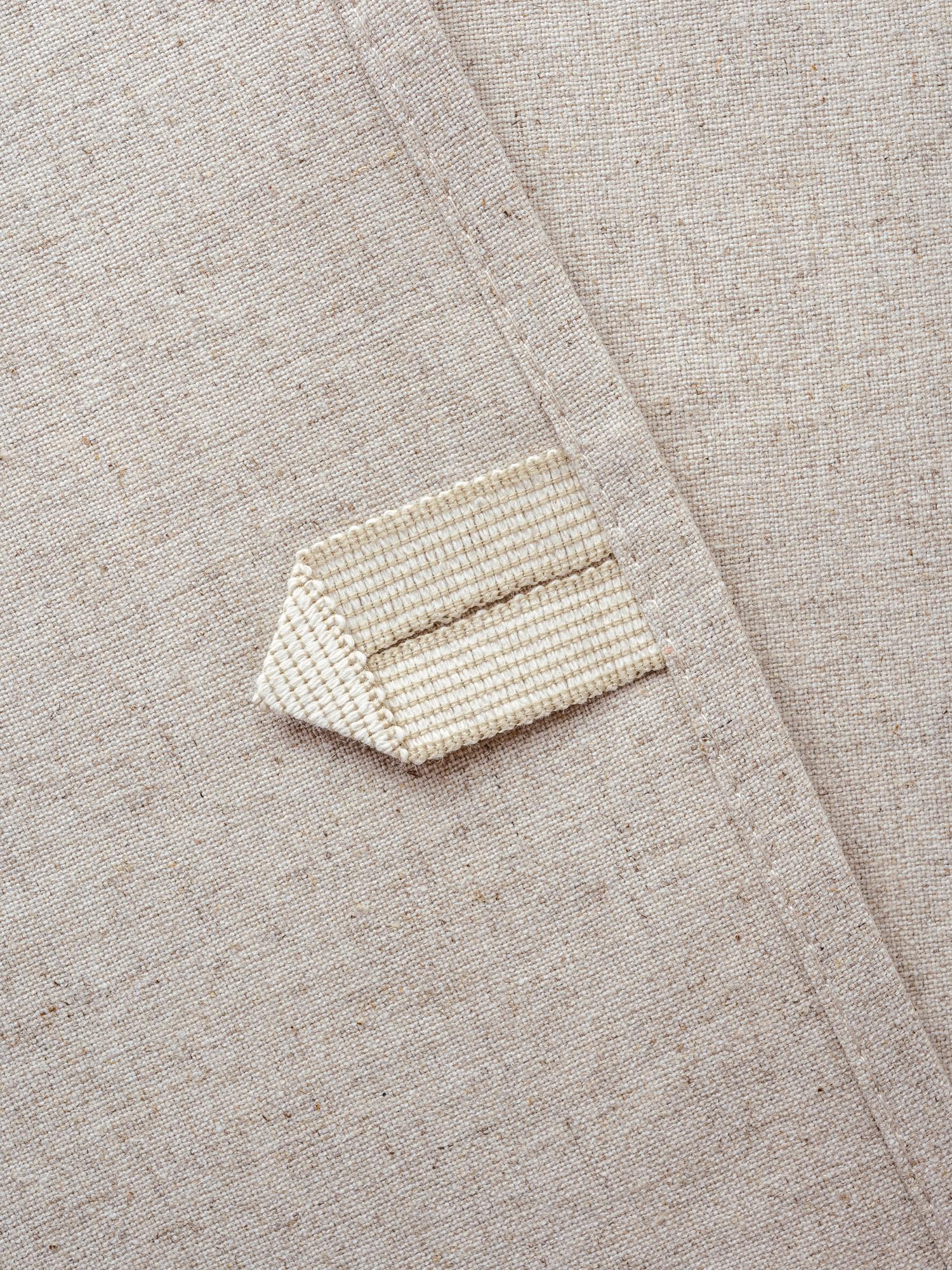 Embroidered linen label on folded garment